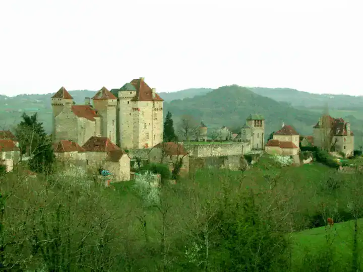 Château médiéval de Curemonte perché sur colline verdoyante